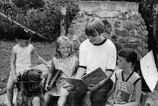 Historical photo of children reading a book