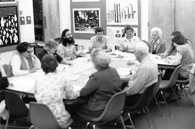 Historical photo of people around a conference table